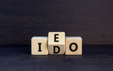 Initial exchange or DEX offering symbol. Concept words abbreviation IEO or IDO on wooden block....