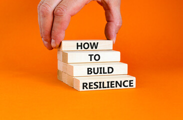 How to build resilience symbol. Concept words How to build resilience on beautiful wooden blocks. Beautiful orange table orange background. Business and how to build resilience concept. Copy space.
