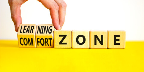 Comfort or learning zone symbol. Concept words Comfort zone Learning zone on wooden cubes. Beautiful white background. Psychologist hand. Business and comfort or learning zone concept. Copy space.