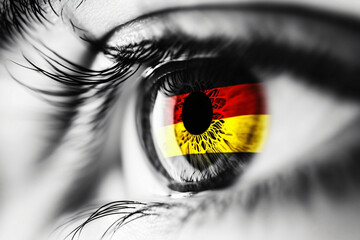 Germany in the Eye: A close-up, black and white photo of an eye with the German flag reflected in the iris.  This powerful image evokes a sense of national pride, cultural identity.