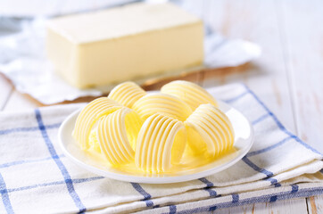 butter swirls in a plate. margarine or spread, fatty natural dairy product.