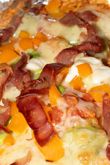Loaded Nachos Close Up with Cured Ham Melted Cheese Jalapenos and Peppers Pizza Style