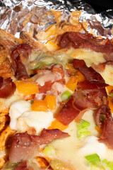 Loaded Nachos Close Up with Cured Ham Melted Cheese Jalapenos and Peppers Pizza Style
