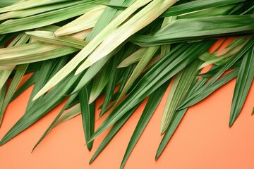 Fototapeta premium Palm leaves with Peach Fuzz color background. pile of green palm leaves on Peach Fuzz color background with copy space. designed for illustration. Palm Sunday illustration 