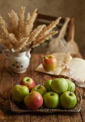 food photo of apples and vintage vase with wild spikelets in a close-up in the style of a country house