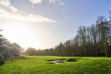 A wintery sunrise over a lucious green golf course