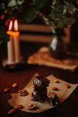 Food photo with chocolate fudge and candles in the background, a concept photo on the theme of Valentine's Day