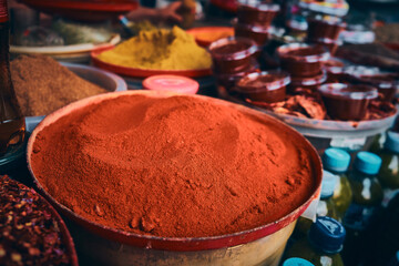 Heaps of grinded saffron and turmeric at bazaar market stall. Colorful heaps of dried spices at...