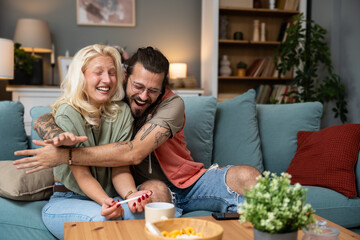 We become parents. Couple feeling happy after taking a home pregnancy test. Happy young couple man...