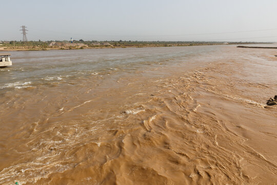Vakhsh river flowing through Kyzylkala in Khatlon Region of Tajikistan during a sunny day
