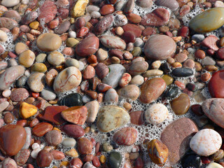 colorful and patterned smooth stones at the beach, england