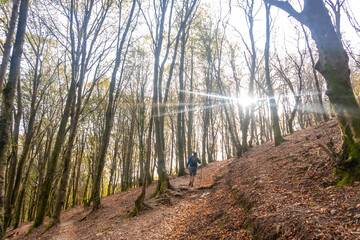 Fototapeta premium Hiker walking up a steep trail in the aiako harria natural park