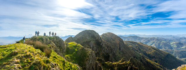 Hikers contemplating breathtaking panorama from aiako harria mountain in basque country