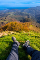 Hiker resting and enjoying the scenic view from mount aiako harria in oiartzun, basque country