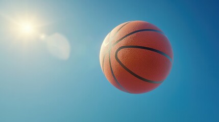 Fototapeta premium Basketball in Flight Against Clear Sky and Bright Sunlight