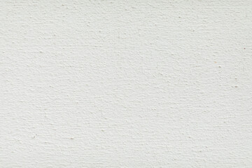 Detailed texture of light gray concrete surface with small gravel and stone aggregates scattered throughout.