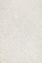 Detailed texture of light gray concrete surface with small gravel and stone aggregates scattered throughout.