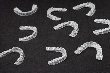 Transparent plastic mouth guard for teeth clenching. Grinding dental bite sleep aid. Dental care.