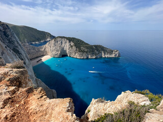 Fototapeta premium A serene view of boats in crystal-clear waters around Shipwreck Beach. Perfect for illustrating tropical escapes, luxury travel, or coastal adventures.