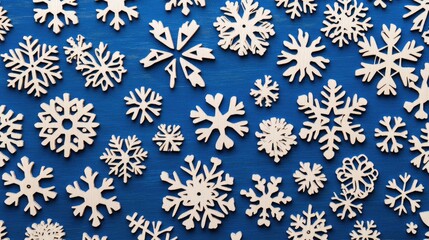 Winter Wonderland Background with Wooden Snowflakes on Blue Surface for Seasonal Themes