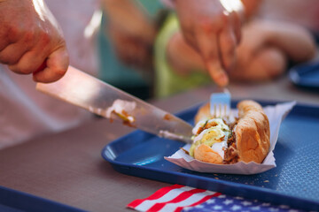 Hot dog on a tray, American flag, eating on time, making hotdogs on time. Unhealthy snack, fast food.