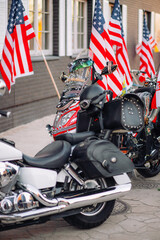 Motorcycle parked on the road, American flag in the background. Copyspace for individual text. Classic motorcycle.