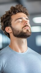 Obraz premium Relaxed Man in Modern Gym Taking a Break from Workout with Closed Eyes and Calm Expression in Fitness Studio, Reflecting Post-Exercise Recovery and Mindfulness, Professional Lifestyle Image
