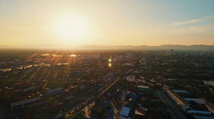 Fototapeta premium Golden Hour Cityscape: An aerial perspective of a cityscape bathed in the warm glow of a setting sun, capturing the intricate details of urban life, buildings, and infrastructure.