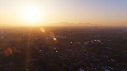 Golden Hour Cityscape: Aerial view of a city bathed in the warm glow of sunrise, mountains in the distance, sun flares adding a touch of magic