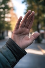 A person with hands raised high in a gesture of surrender or celebration