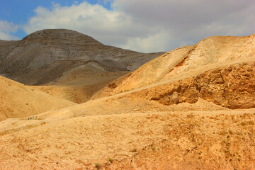 Desert landscape in the Judean Desert, featuring rolling hills and sparse vegetation