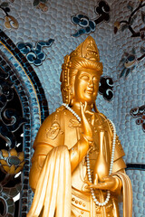 Da Lat, Vietnam - December 24, 2024: Golden  statue in the Linh Phuoc Pagoda in Da Lat city (Dalat), Vietnam. Da Lat is a popular tourist destination of Asia.