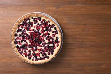 Delicious currant pie on wooden table, top view. Space for text
