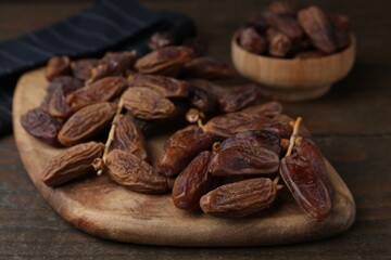 Tasty dried dates on wooden table, closeup