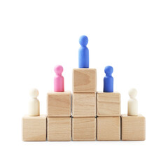 Human figures on wooden blocks, blue one on top against white background. Competition concept