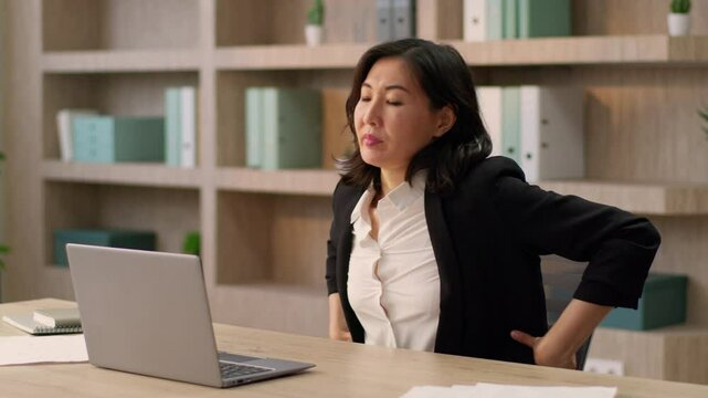 Tired Asian businesswoman sedentary computer work at office desk exhausted korean chinese girl japanese business woman feel ache neck suffer pain spine muscles backache health problem overwork laptop