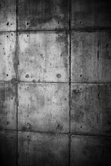 A grayscale image of a rough concrete wall with texture and imperfections