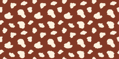 Minimalist seamless animal print, deer skin pattern with cream irregular textured spots on brown background for textiles, wallpapers, wrapping paper, fabric.
