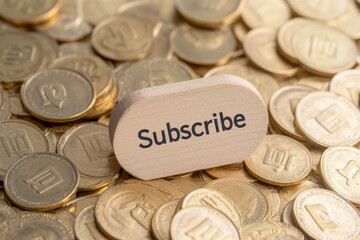 Wooden subscribe button on a pile of coins representing digital currency engagement and commitment in online content