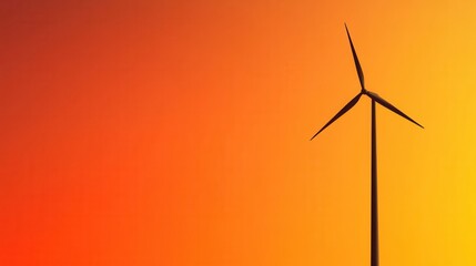 Fototapeta premium Wind Turbine Silhouette Against Vibrant Orange Sunset Sky Background