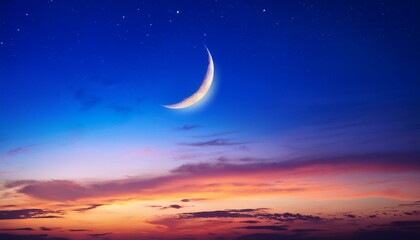 nightfall sky with colourful sunset after sun down and crescent moon on dark blue hour twilight