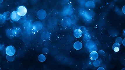 Abstract blue bokeh background with bright lights and dark space.