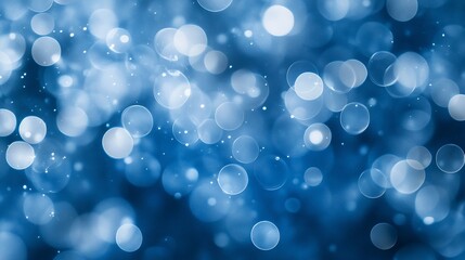 Abstract blue bokeh background with blurred circles and sparkles.