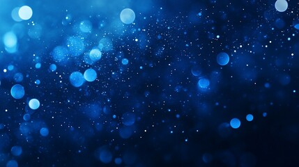 Abstract blue bokeh background with glowing lights and sparkles.