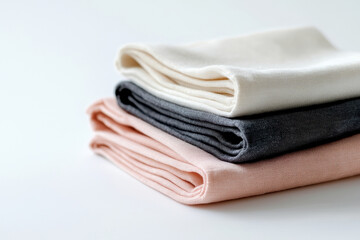 Three neatly folded fabric pieces in pastel colors, perfect for home decor.