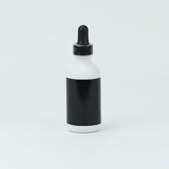 A white supplement tincture bottle with a black dropper an blank label for wellness concept