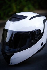 Fototapeta premium A close-up shot of a motorcycle helmet on a street, perfect for use in travel or adventure-related contexts