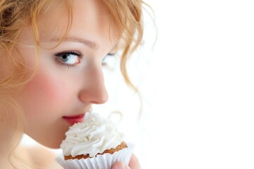 A person covering their face with a cupcake, great for humor and food-related concepts