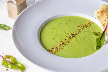 Green pea cream soup and cheese chips