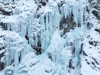 Waterfall that has turned to ice in the mountain. Drone photo from Norway.